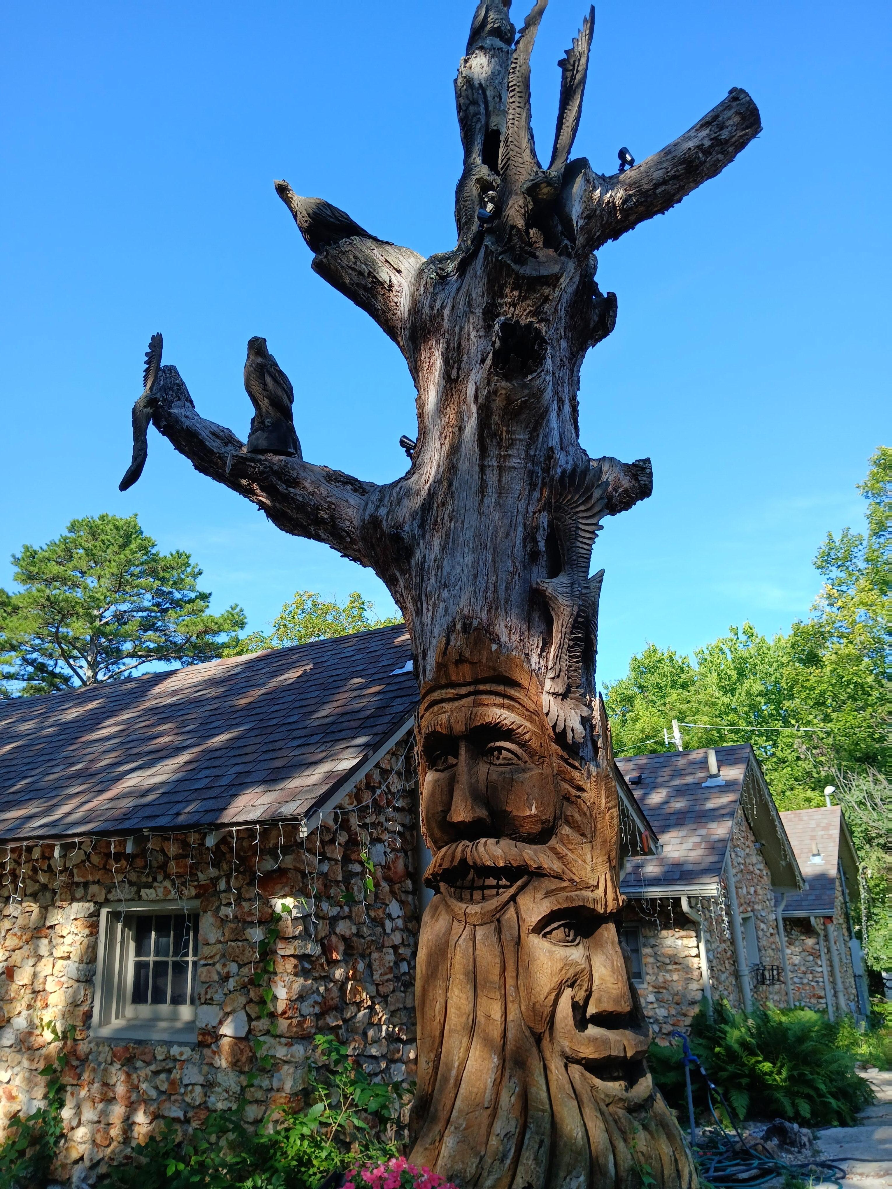 Carved tree in front of cottages