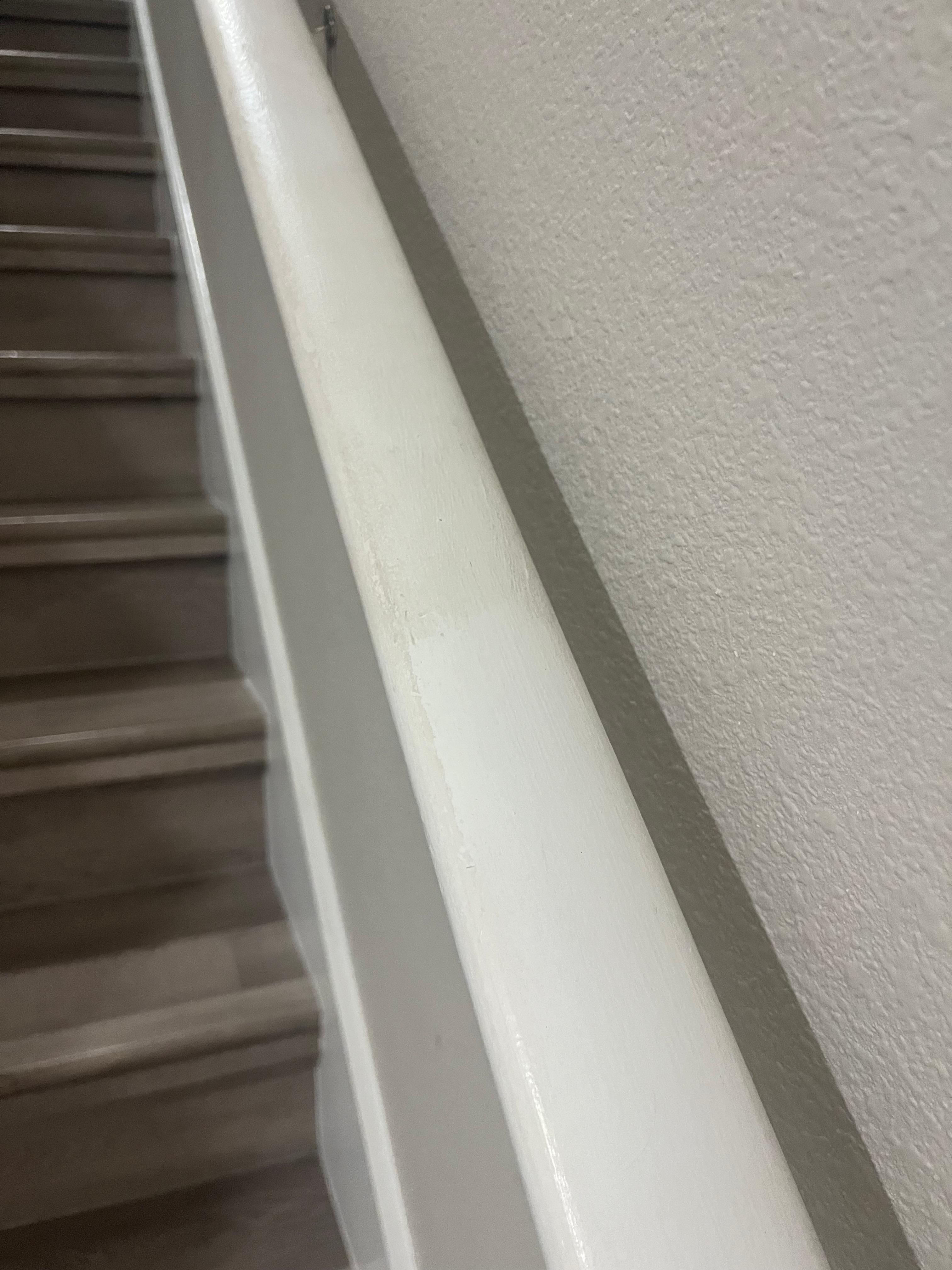 Handle leading to upstairs that we had to clean as soon as we arrived. You can see the filth!