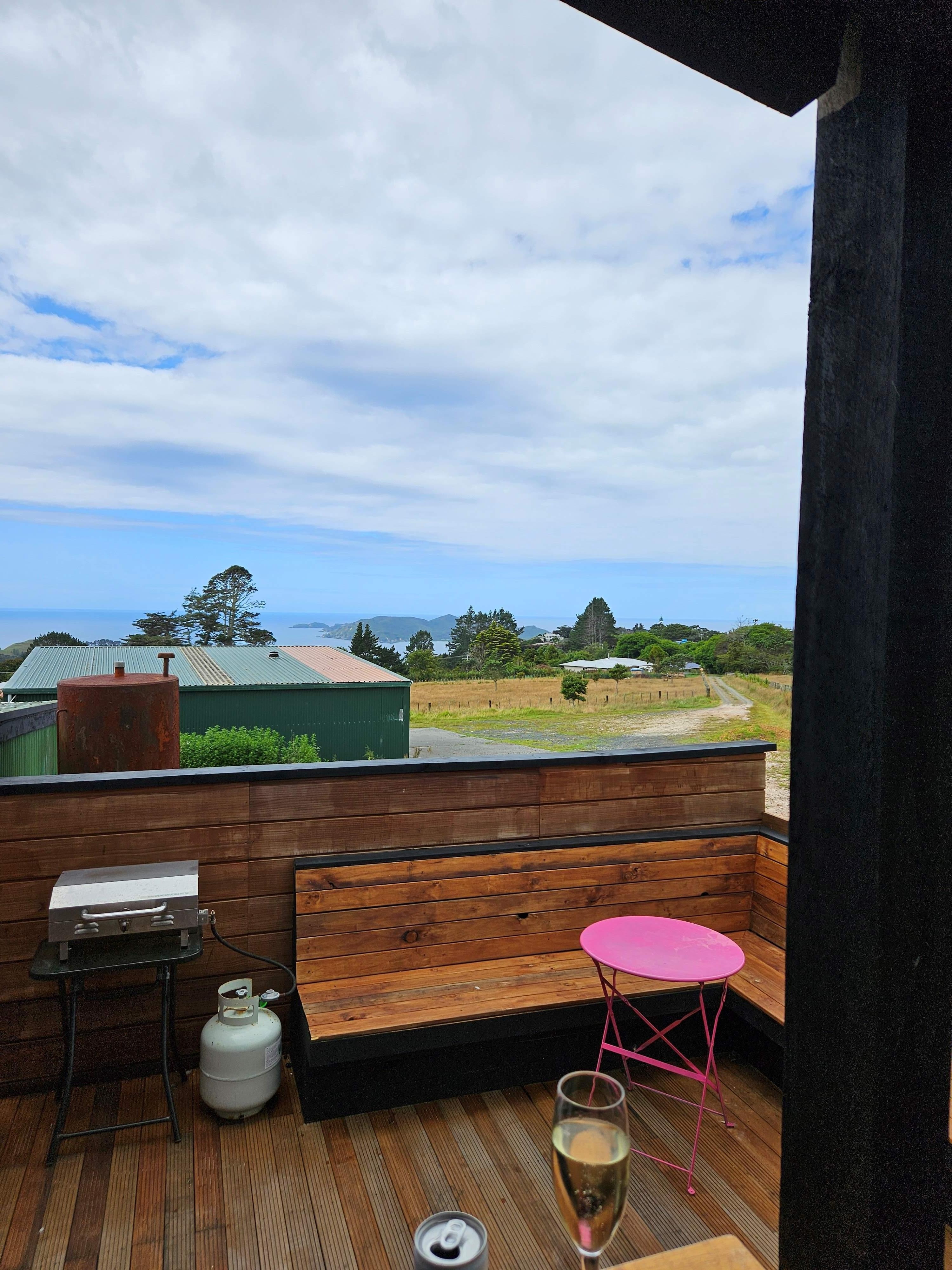 Matauri Bay view at the front of the property and a glass of champagne