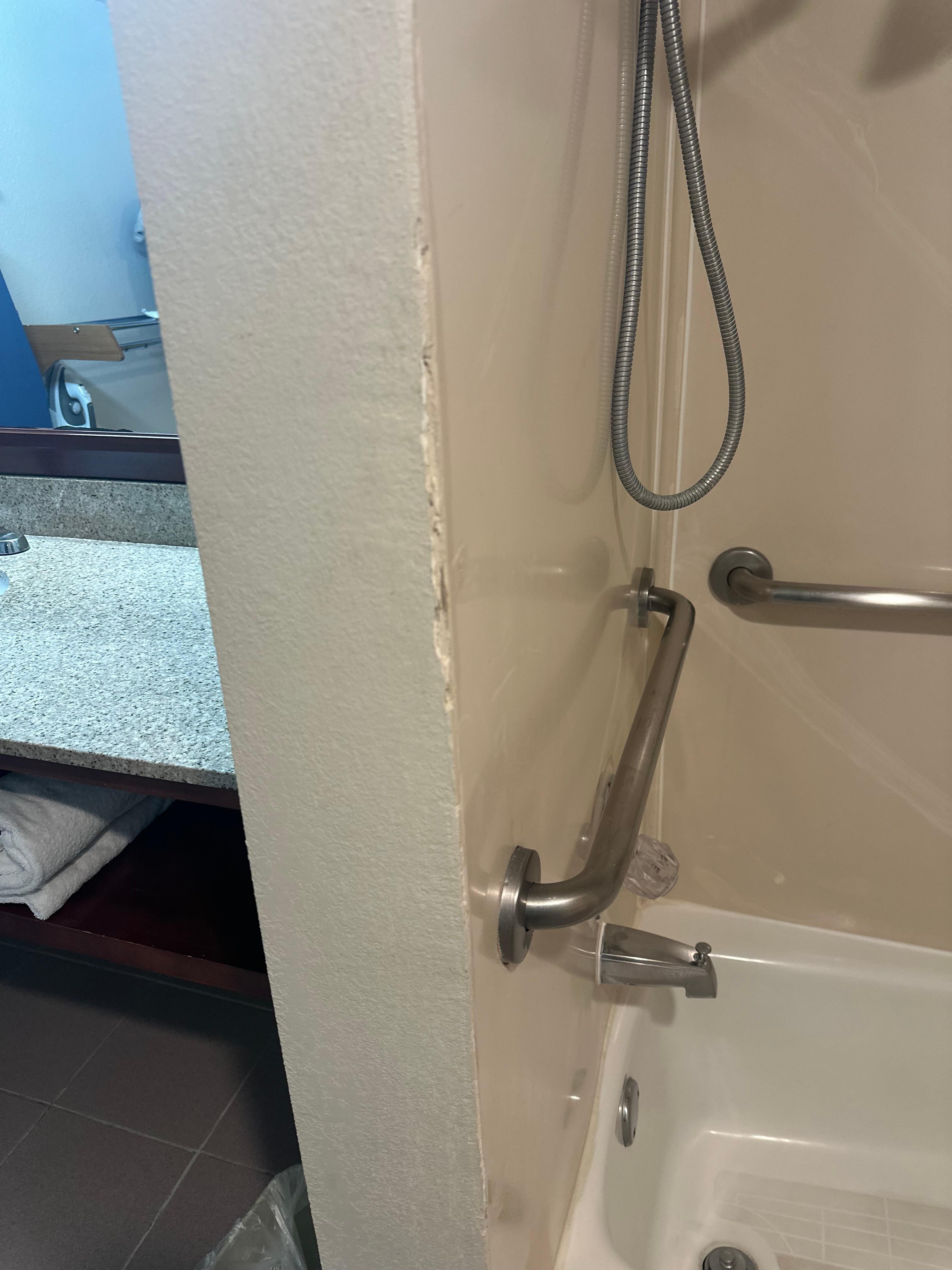 Cracked and dirty wall by shower