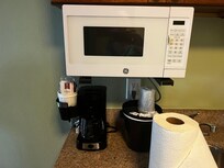 Microwave, stovetop, coffee pot, and a full roll of paper towels!