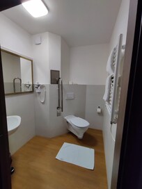 Standalone toilet without room to move if sitting down.