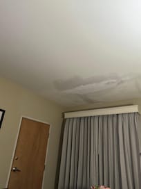 Ceiling in our room after rain. Very obvious wet marks and crack in their fix.