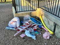 Trash left in pile next to back patio