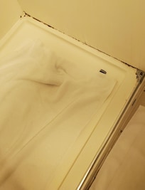 Shower stall, towel put down to stand on