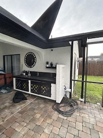 Camera facing pool/lanai area. One is also on the exterior wall right outside the screen door.