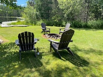 Seating by fire pit near lake