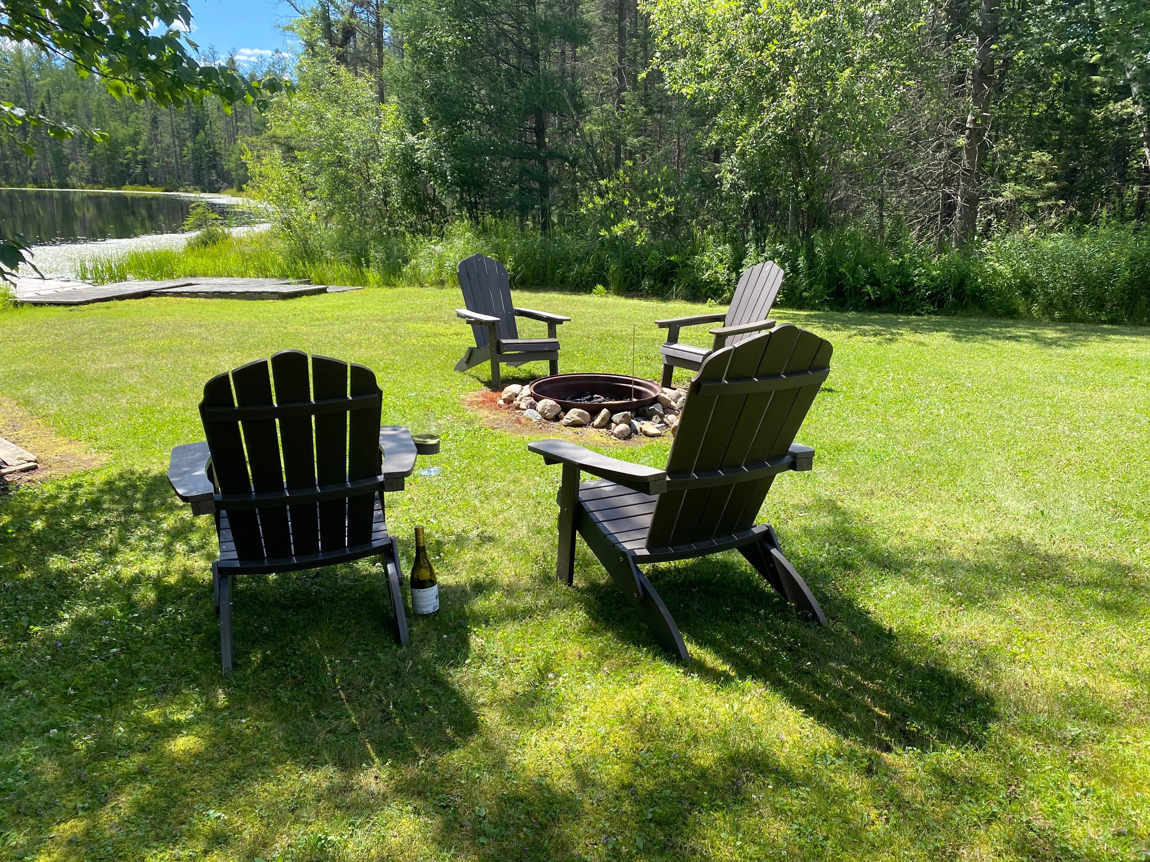 Seating by fire pit near lake