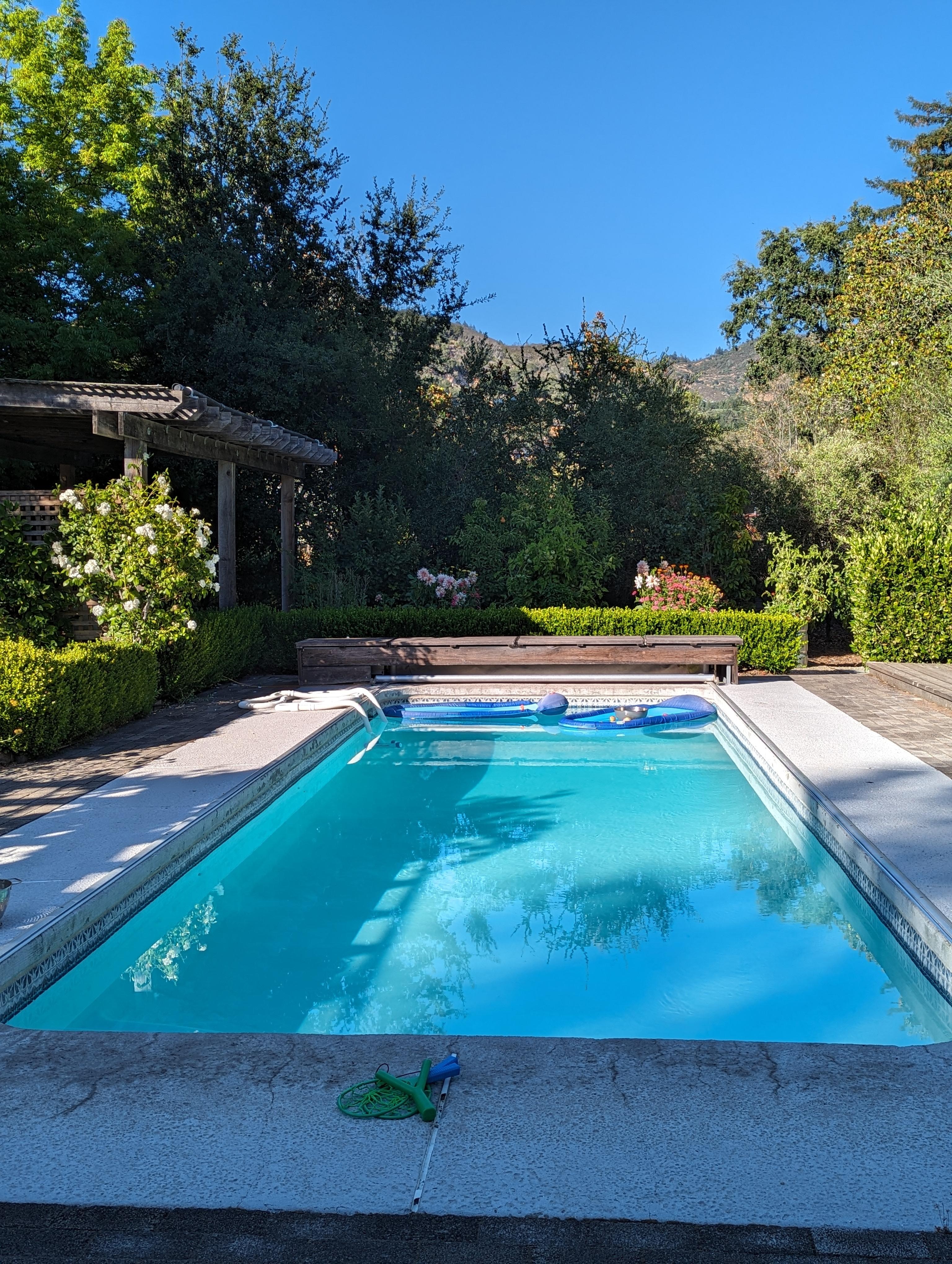 Loads of fun at the pool. Lots of lounge chairs, beach towels, floaties.