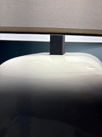 Tooth is on top right of lamp.