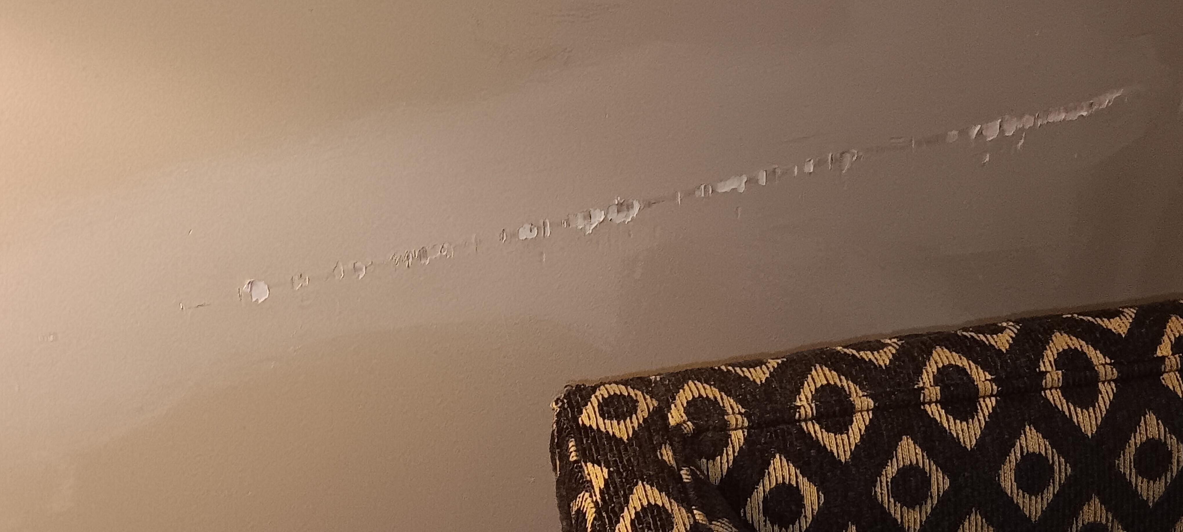 damage on wall from chair