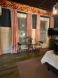 A table to eat at and the windows overlooking the street. There is train tracks across the street and you will hear a few trains.