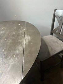 Weathered table and stained chairs