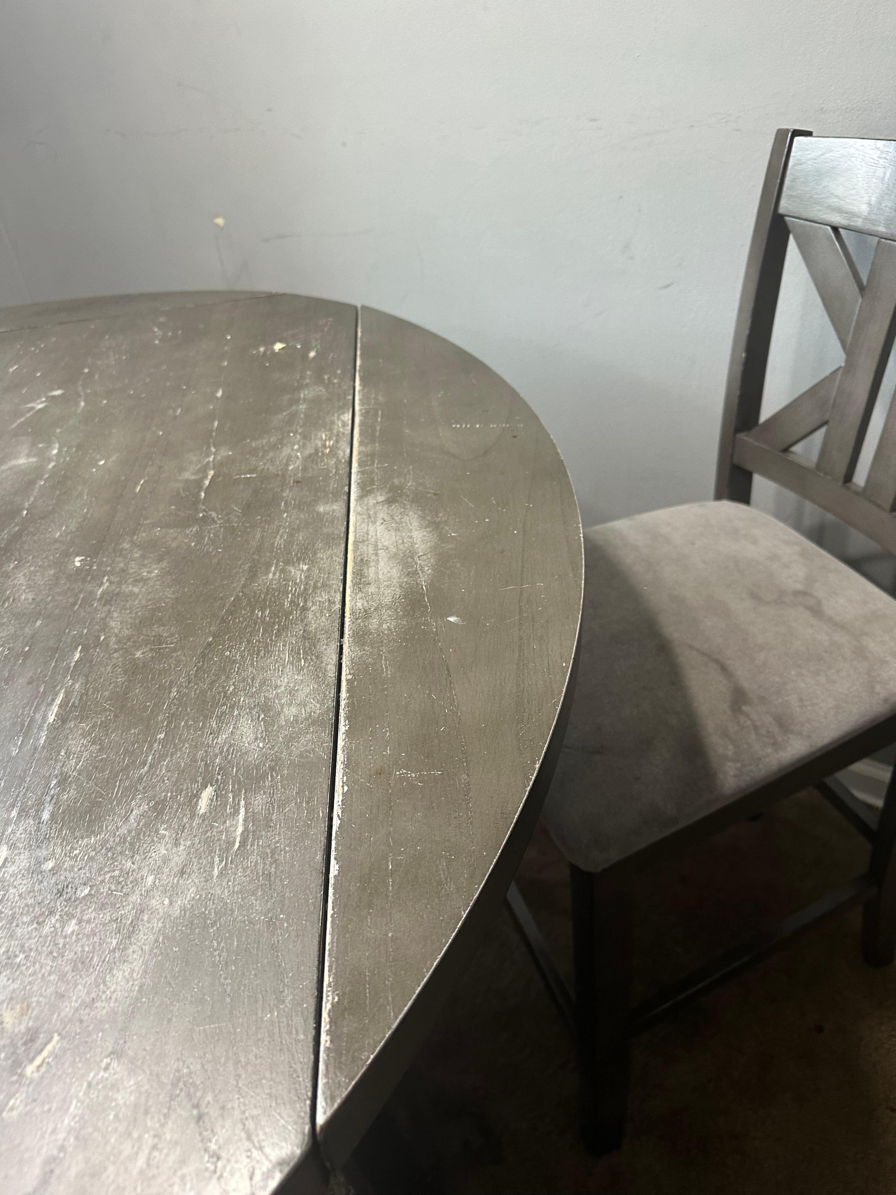 Weathered table and stained chairs