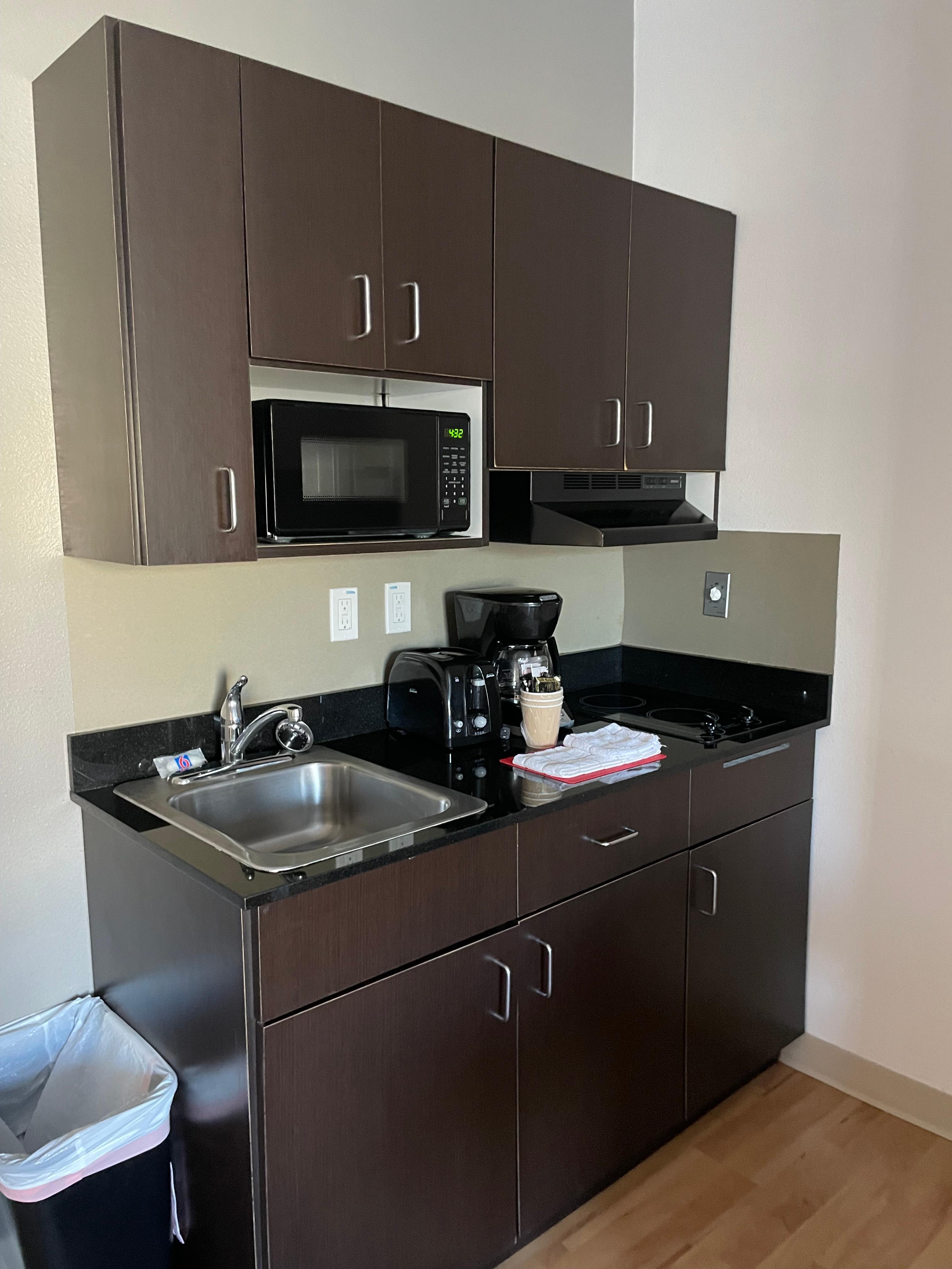 Kitchen with mini stove, microwave, fridge, coffee maker, toaster and towels 