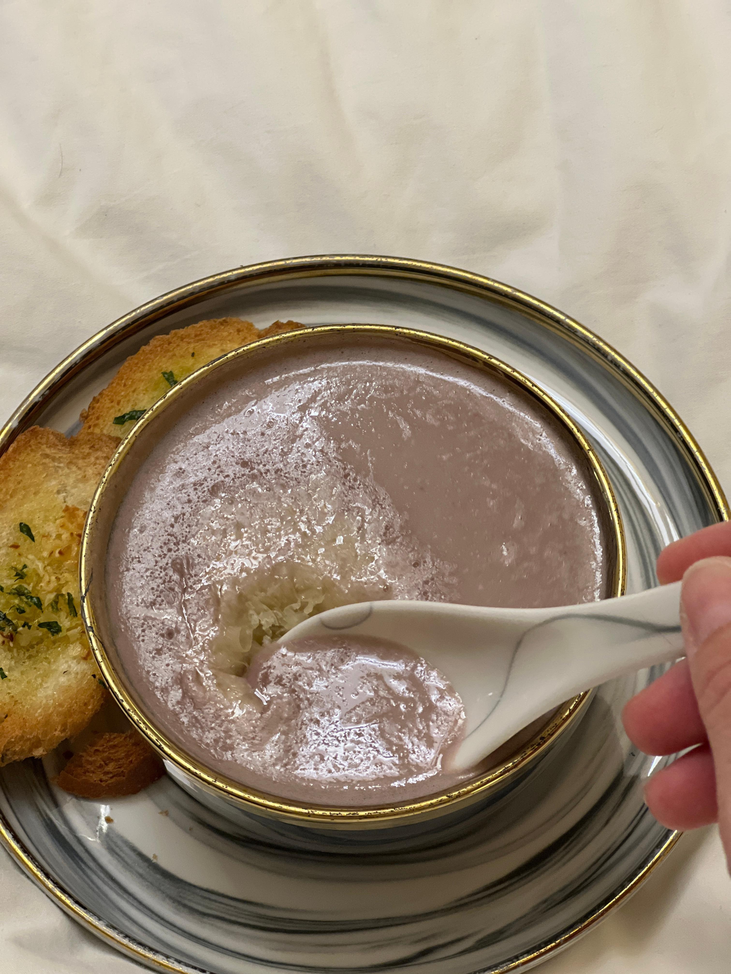 Blue potatoe soup with Parmesan cheese 