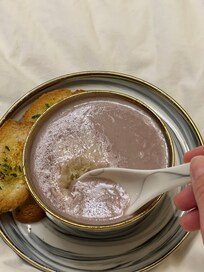 Blue potatoe soup with Parmesan cheese