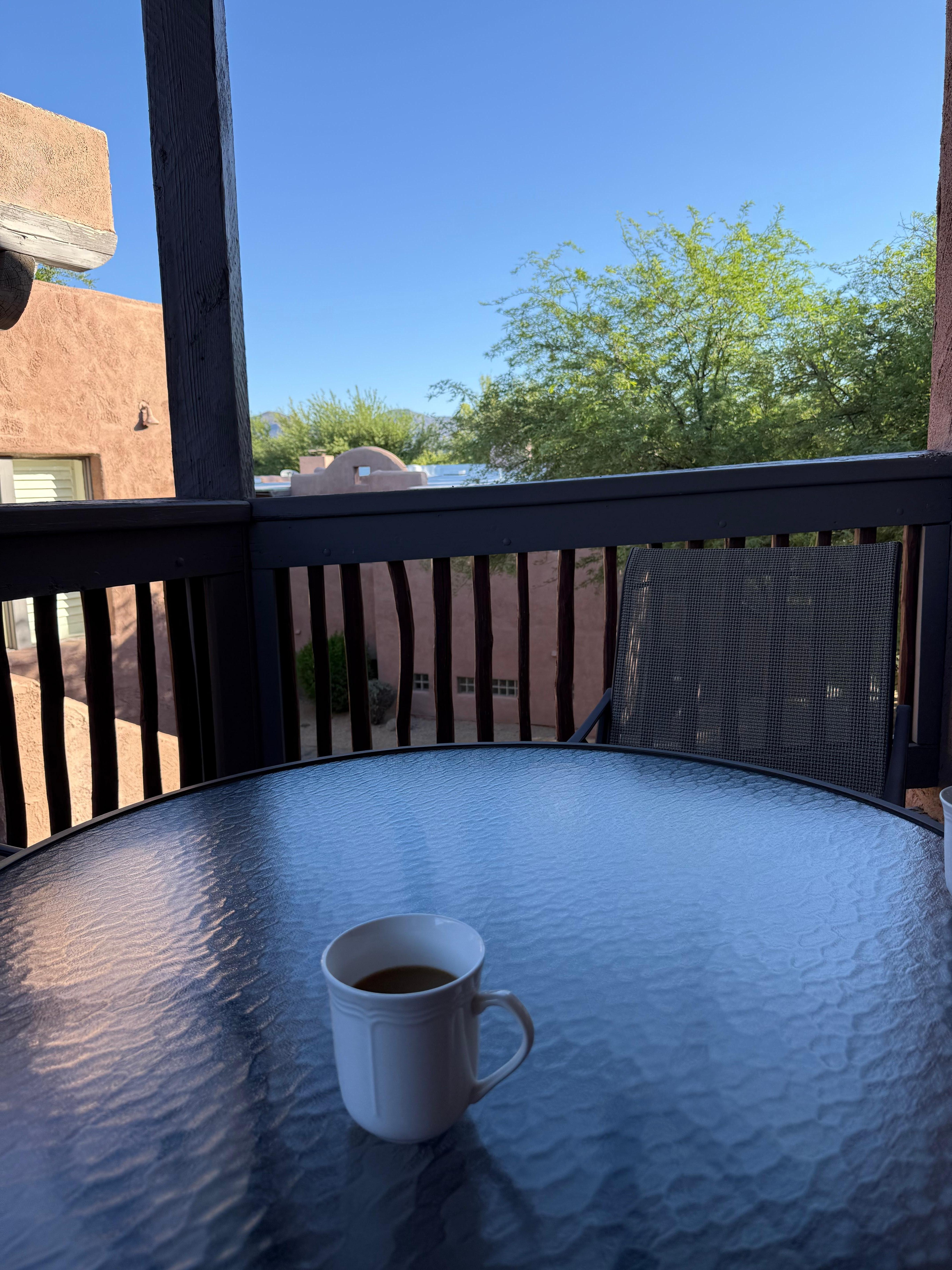 Patio set with view of the mountains and hotel grounds 