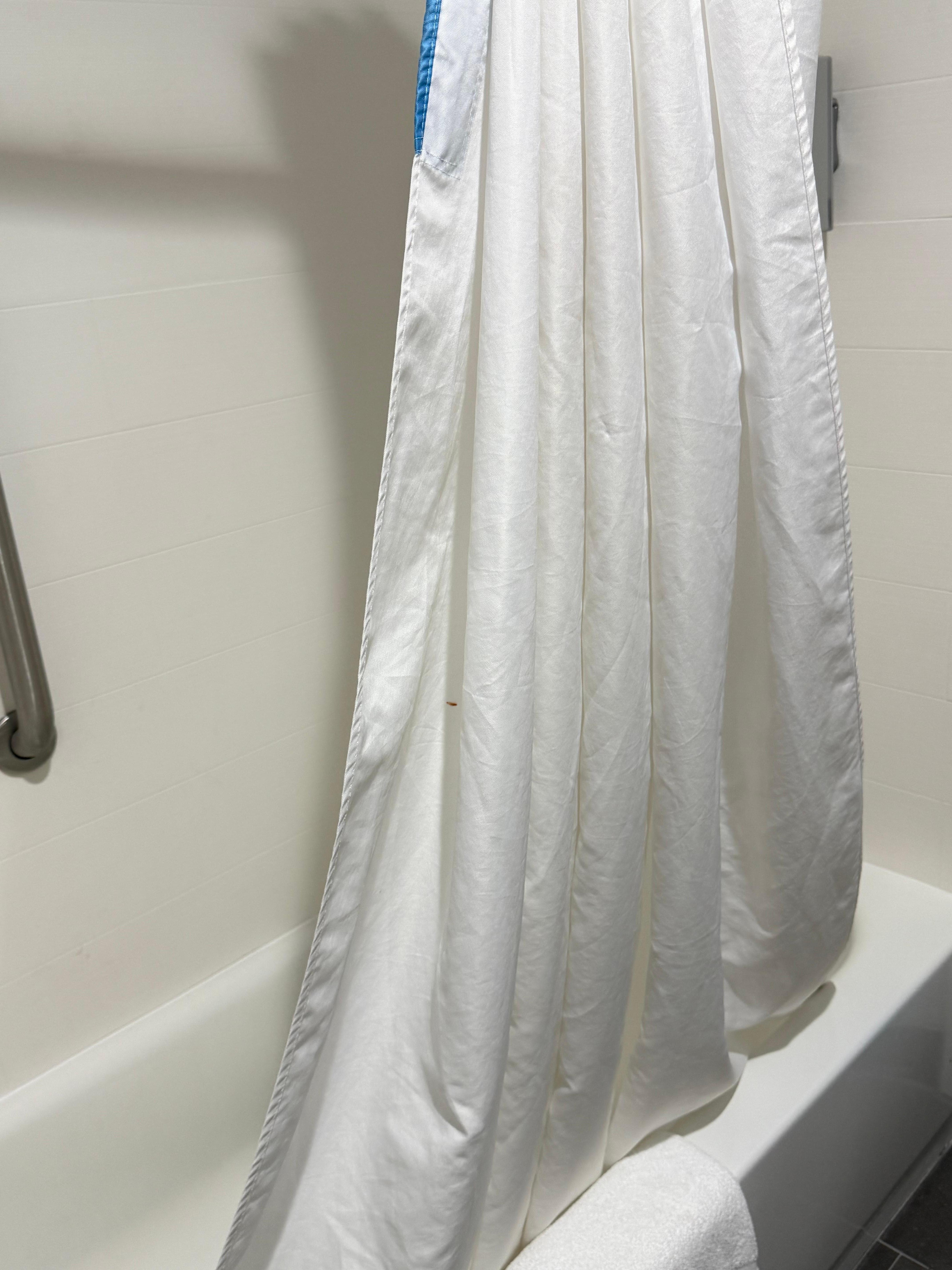 Stain on shower curtain, change that thing out for the amount you charge, sheesh.