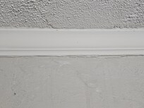Moisture stains and paint peeling off on the ceiling