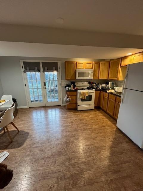 This is a view of the kitchen area.  (deep sink, large refrigerator, and electric stove/oven).  There were pots, pans, silverware, dishes, cups, etc. There was a toaster, coffee maker and a hot water pot! The kitchen was well stocked. 