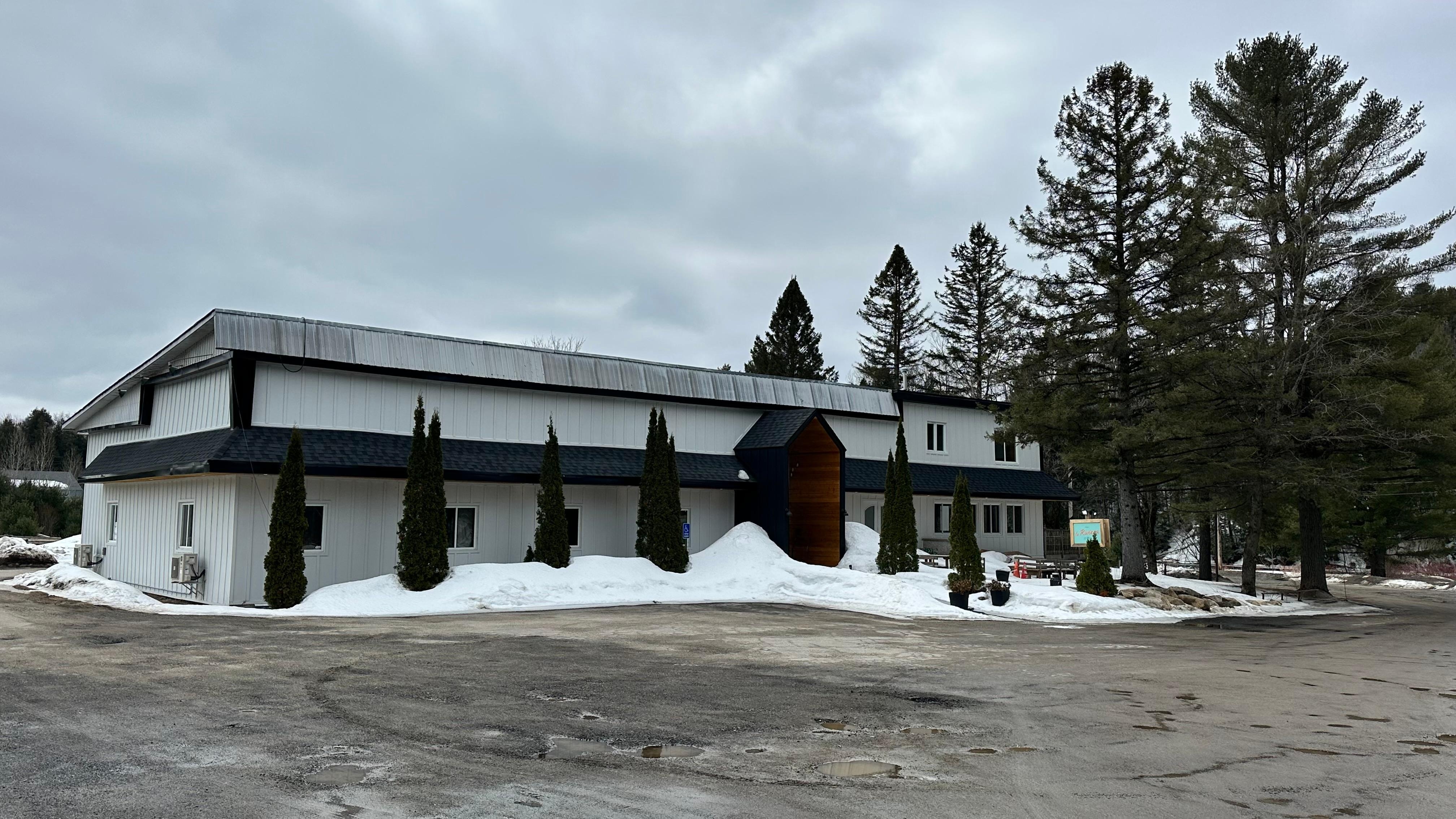 Back view with lots of parking around building