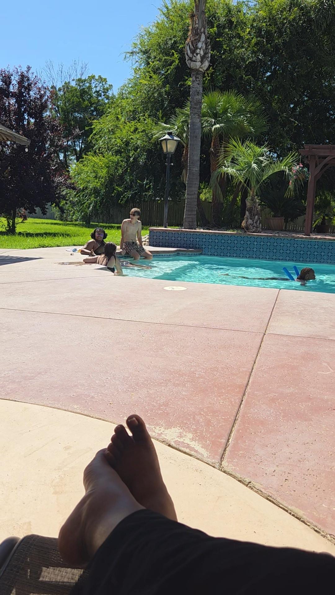 Family enjoying the pool while Momma sits with feet up!