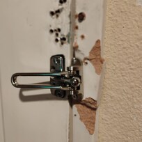 The unreliable door frame “supporting” the extra door lock.
