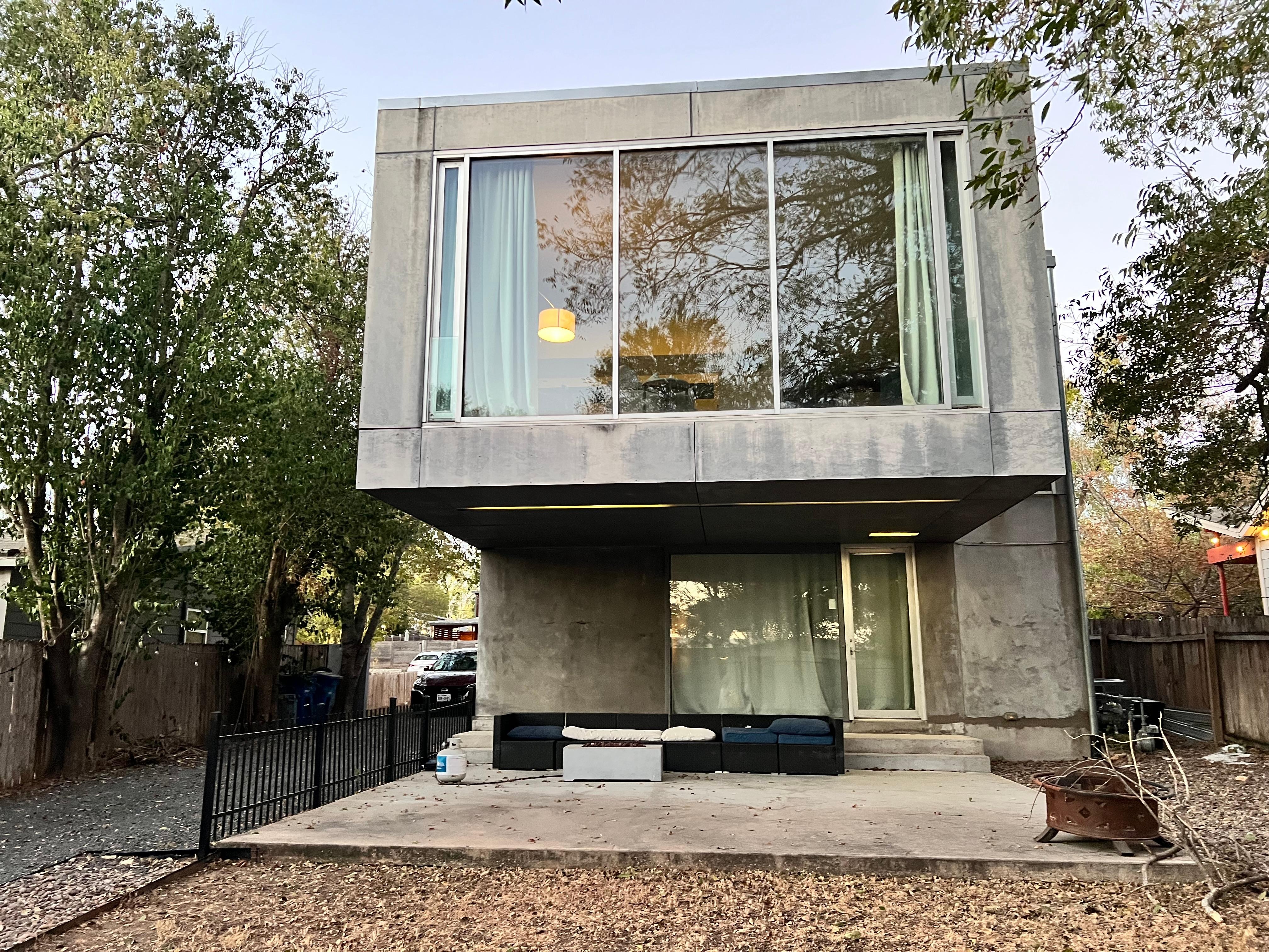 The main house has one bedroom with a door, the other is located in an open space with no door.
