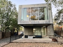 The main house has one bedroom with a door, the other is located in an open space with no door.