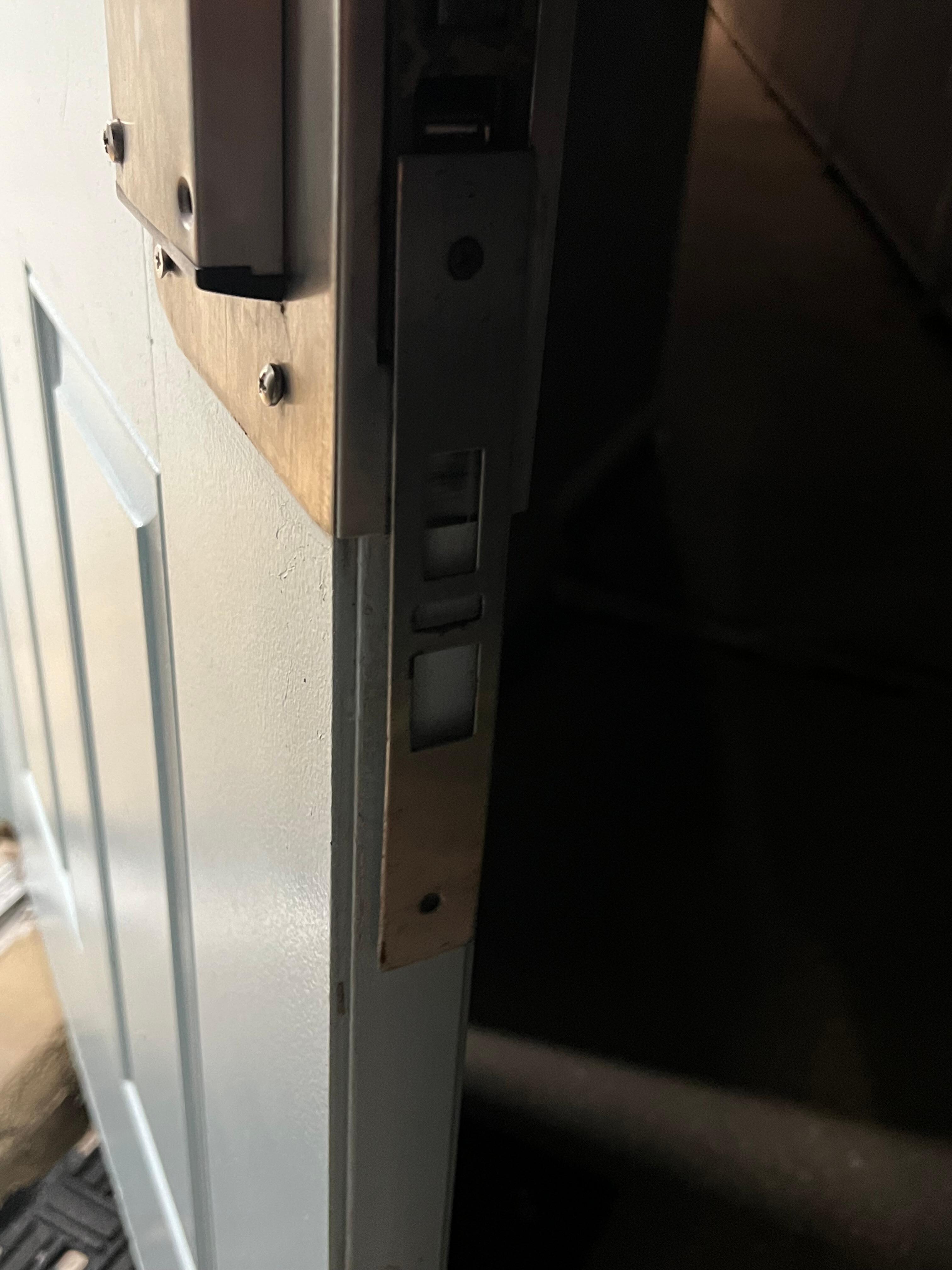 metal doorjam hanging off, door not secure