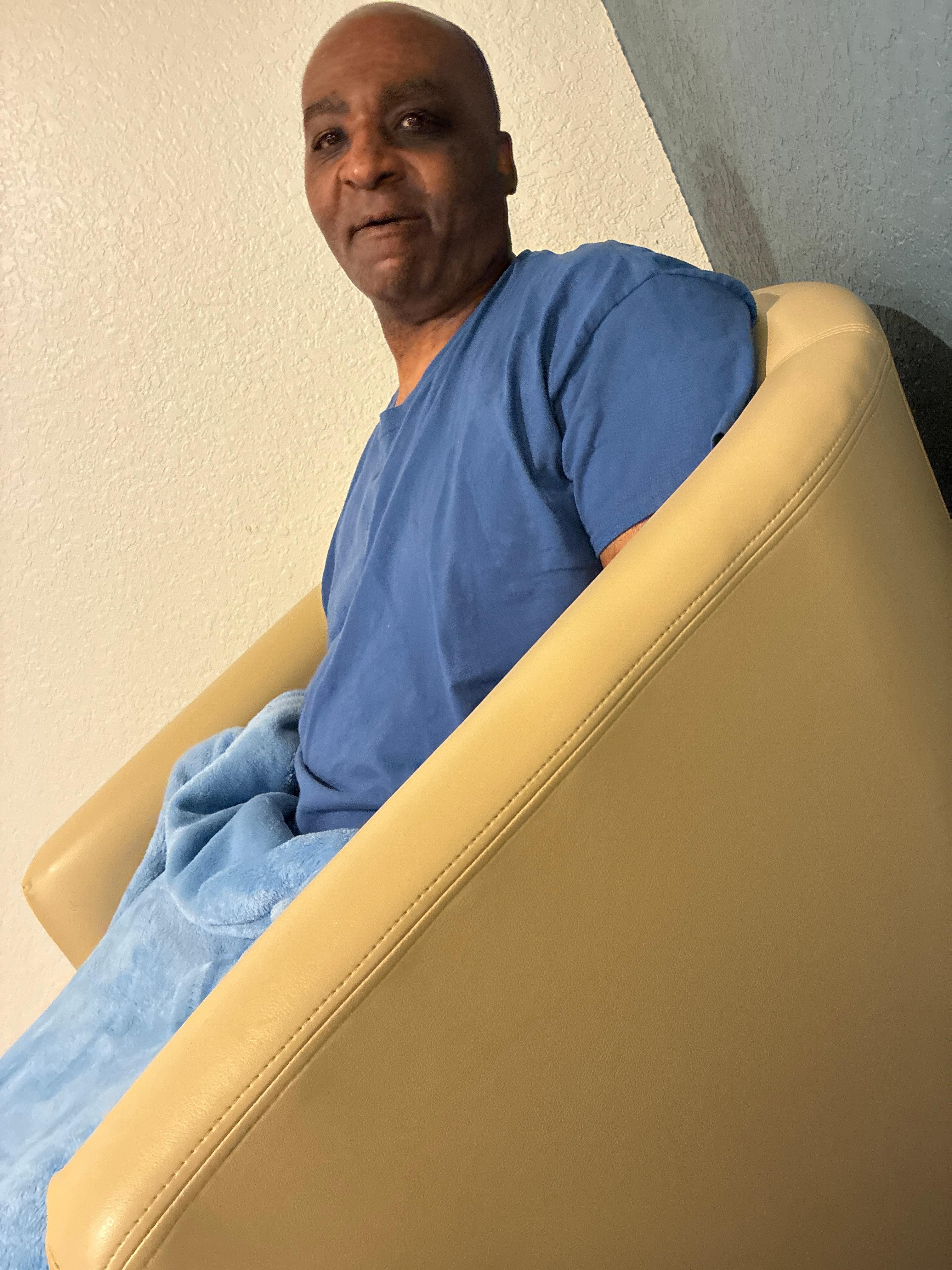 Hubby sitting in the chair watching predator after me and him had food from Baci restaurant 😋