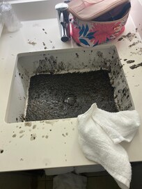 Photo of the sink after we started to wipe it up all around the sides.