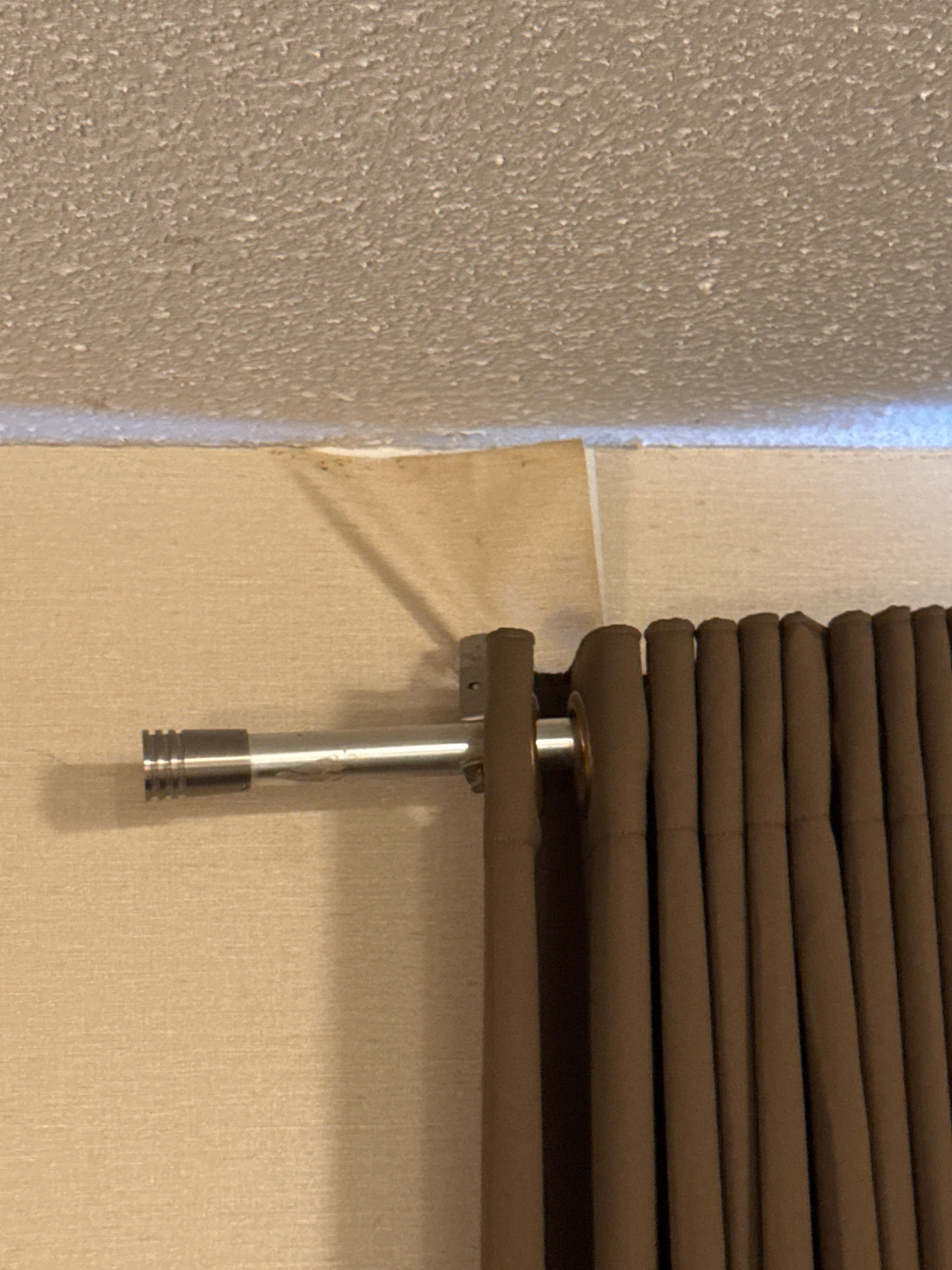 Shower curtain rod for curtains with peeling wall paper hanging
