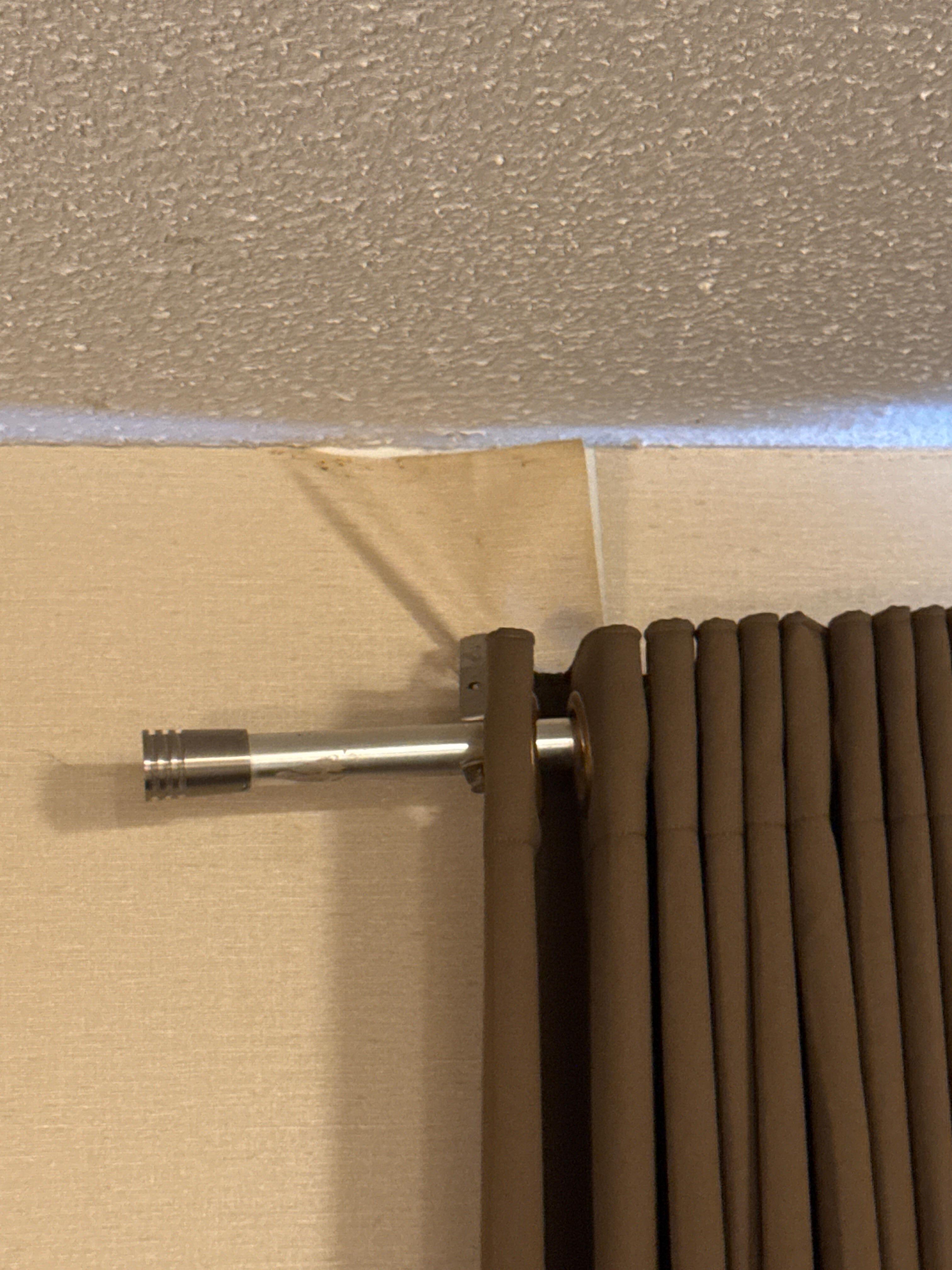 Shower curtain rod for curtains with peeling wall paper hanging