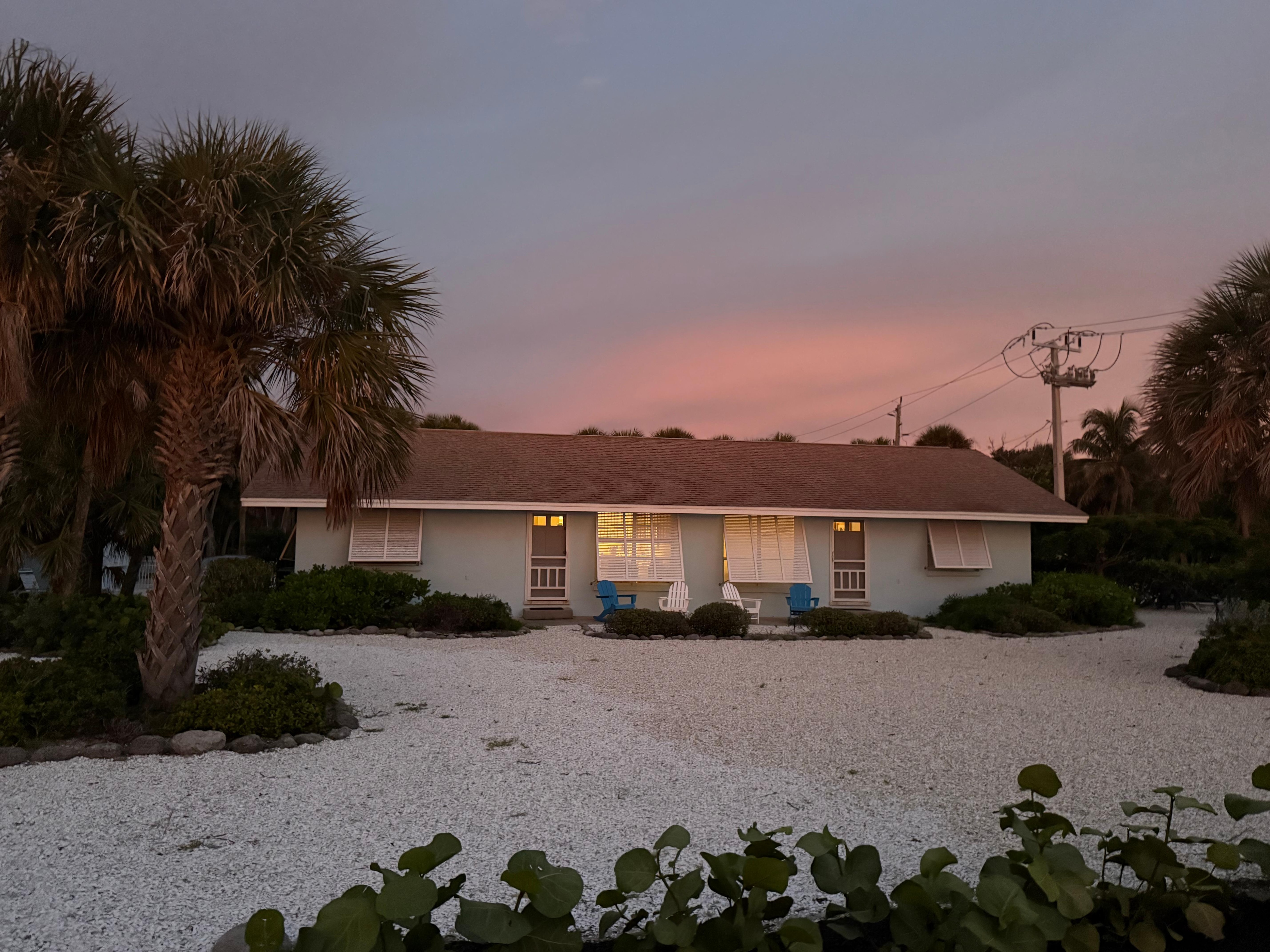 The sunset casting an orange glow on the house.