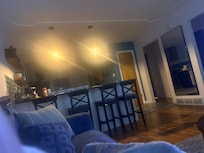 From the couch looking into the kitchen with a gorgeous island and very inviting antique lighting. So homey and beautiful and inviting