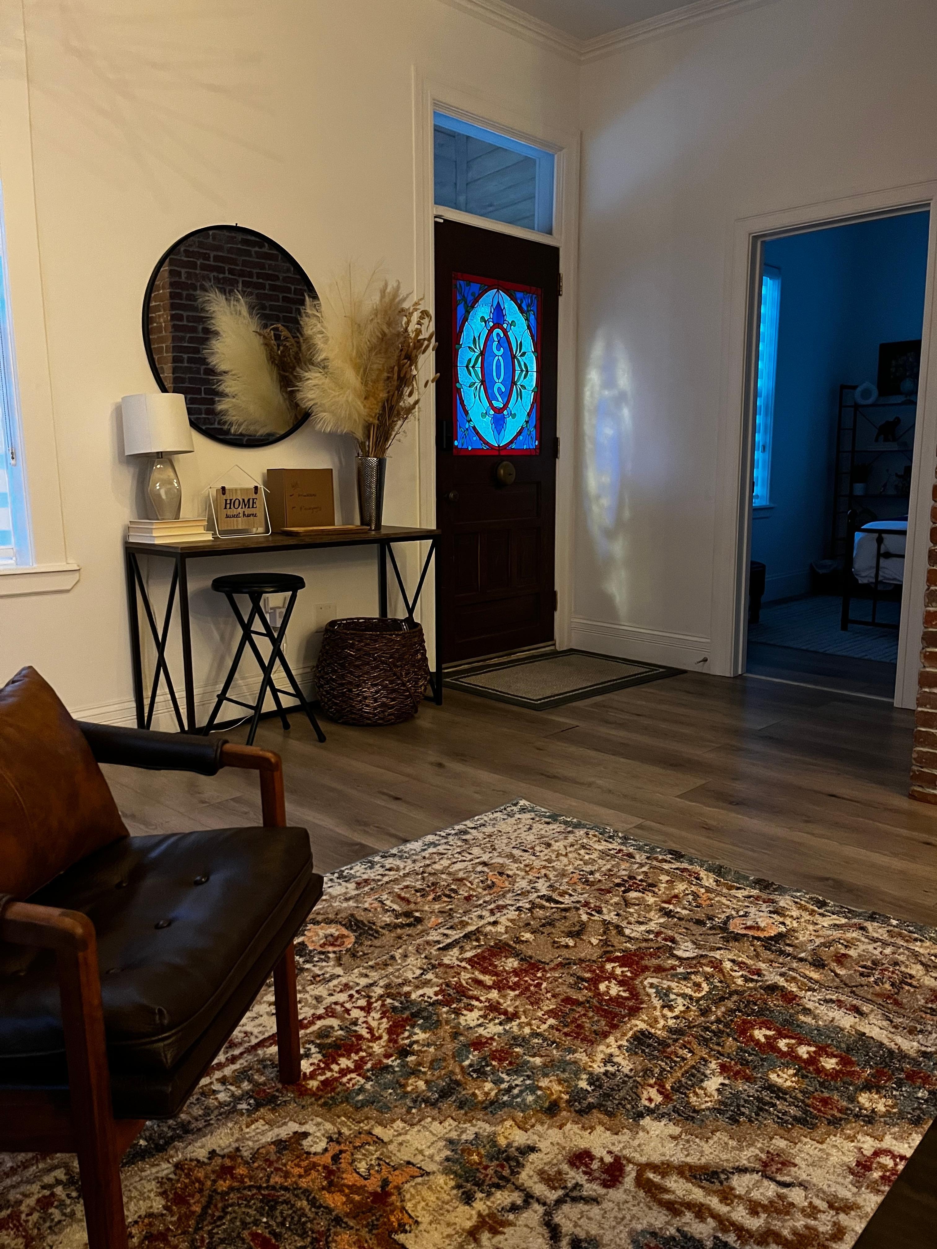 Sitting on the couch toward front door. Cozy fireplace!