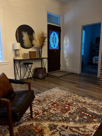 Sitting on the couch toward front door. Cozy fireplace!