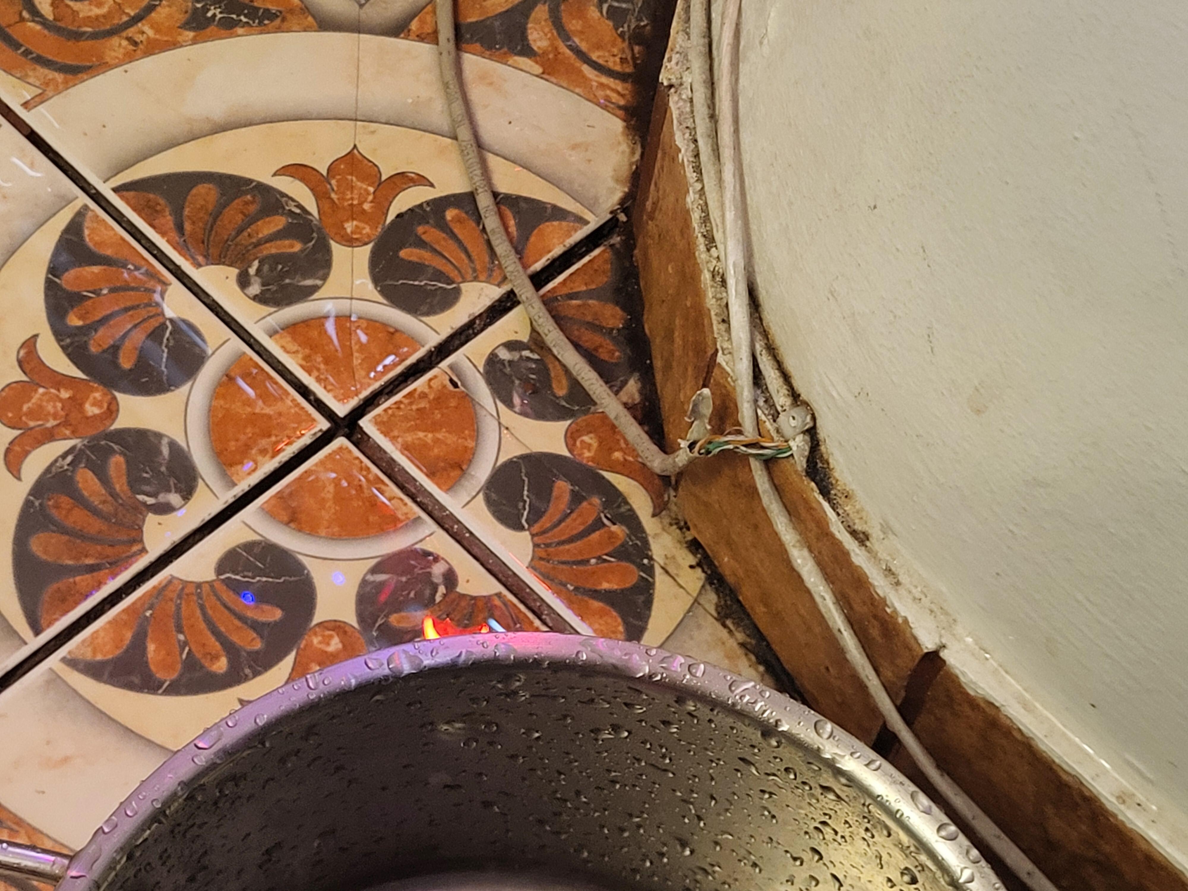 an exposed wire getting wet from the leaking ceiling