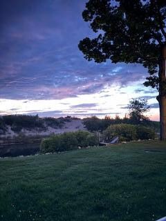 Photo from standing on patio looking at the Crystal river and lake michigan just over the small dune. 