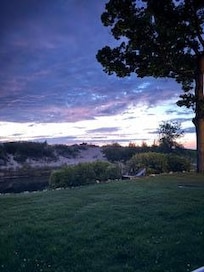 Photo from standing on patio looking at the Crystal river and lake michigan just over the small dune.