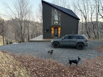 The top driveway and front door area. More parking down below.