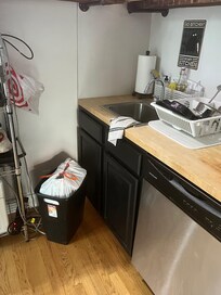 Kitchen trash full and dishes not put away