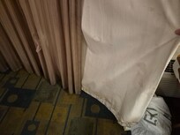 Filthy sun block and torn curtain
