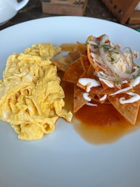 Breakfast scrambled eggs and chilaquiles also came with friut