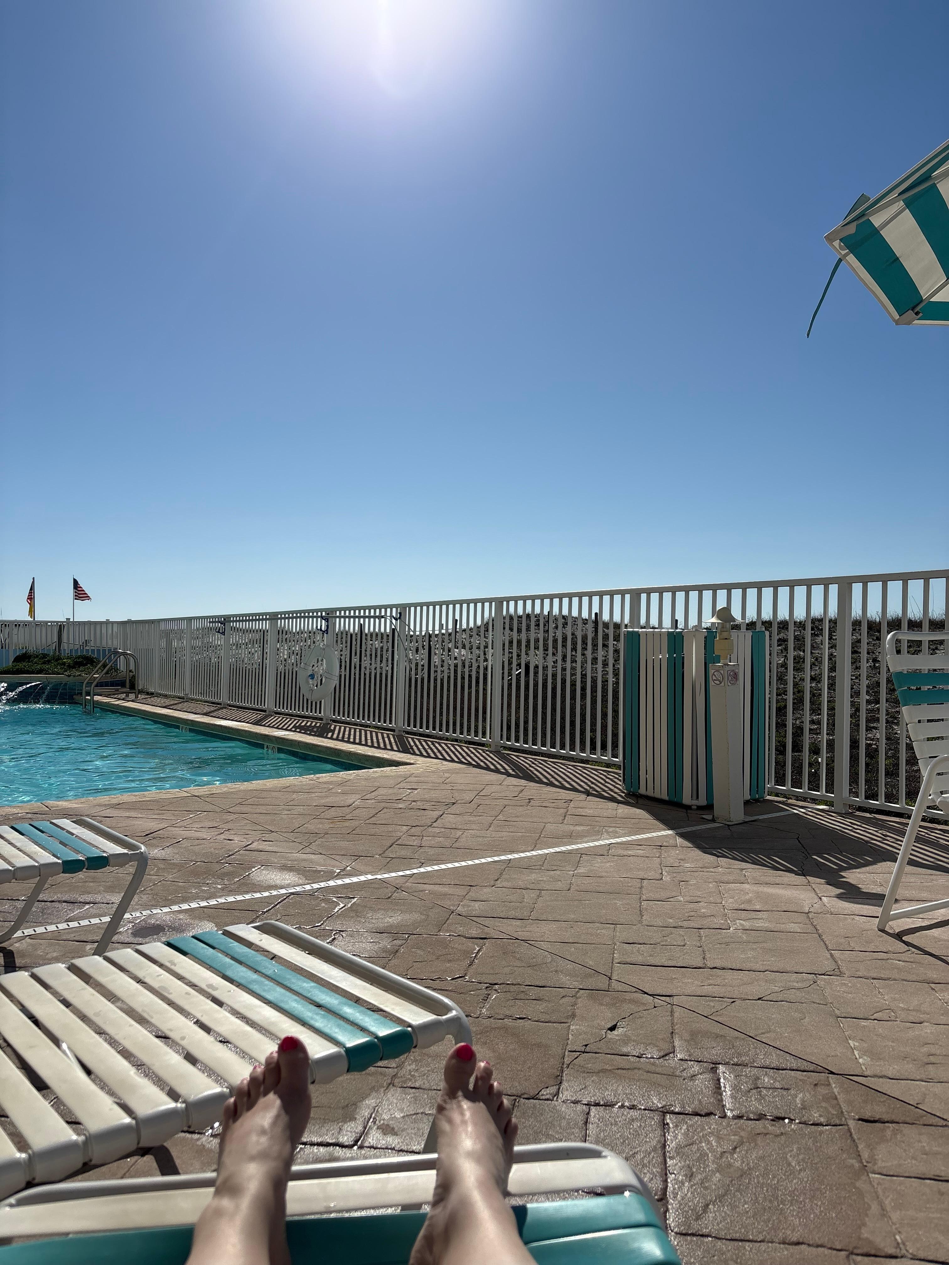 Laying at the pool looking over the beach