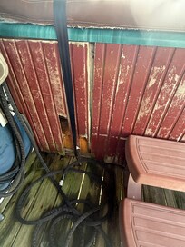 Hole bottom left corner of hot tub.