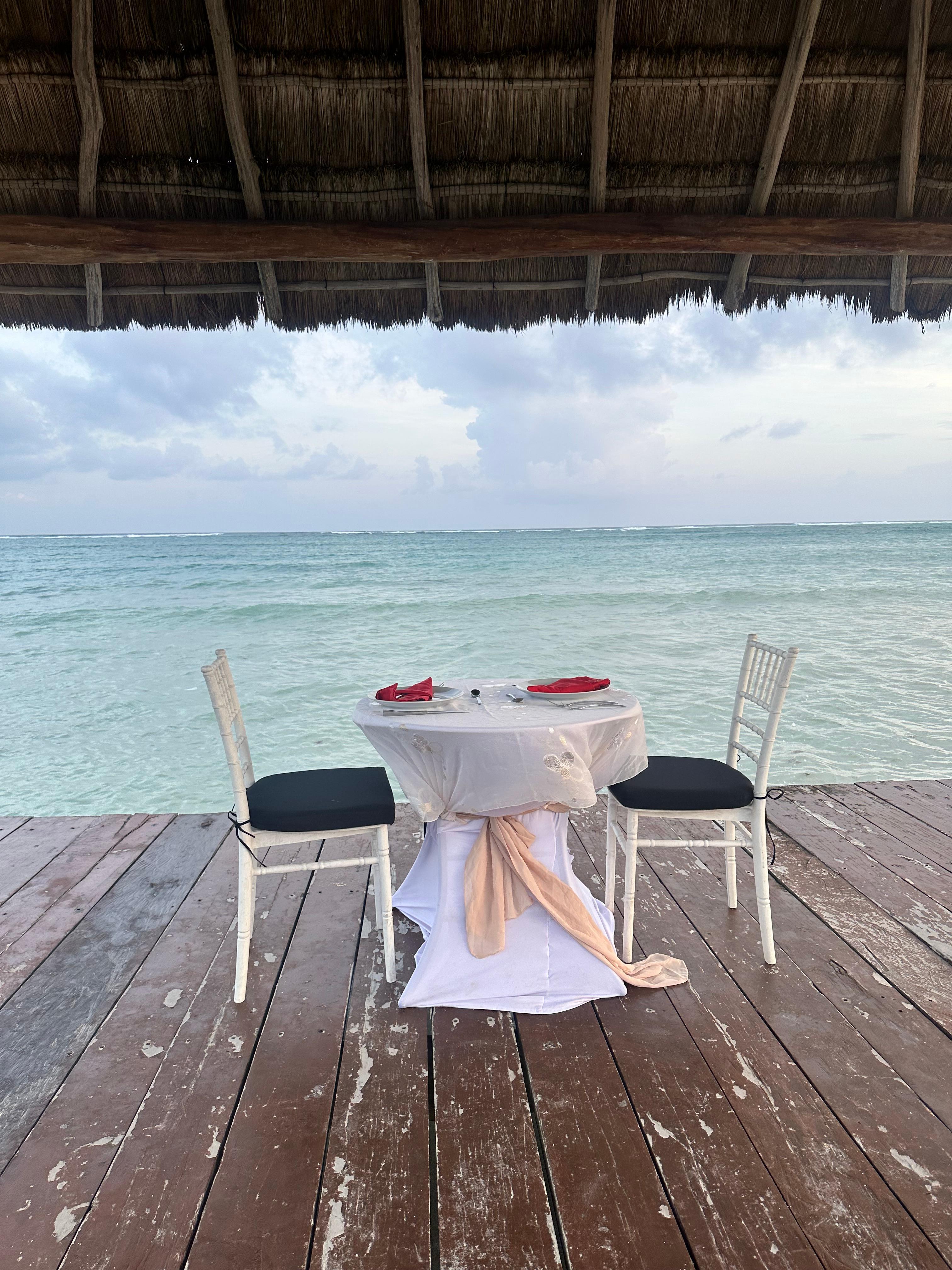 Staff set up a romantic dinner on dock