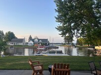 Our boat at the dock; view from backdoor of cottage! You can see the canal & lake ahead!